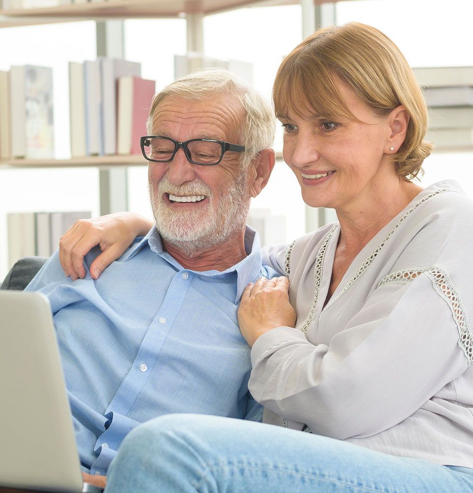 mature married couple contemplating dental implants together